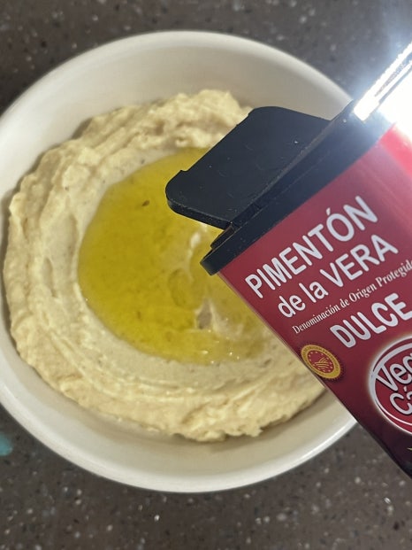 IMG_4195 a bowl of hummus with a red container